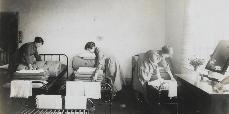 Women's Army Auxiliary Corps personnel making their beds in billets, c1917