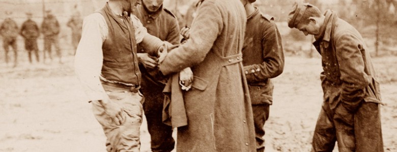 Soldiers treat a wounded German prisoner of war, 1917
