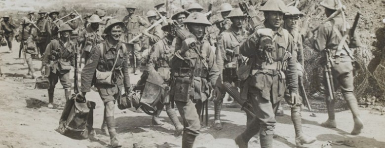 A Vickers machine gun team marching past a working party heading in the opposite direction, 1916