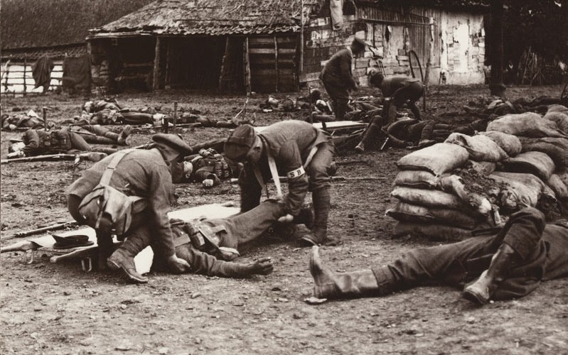 'Tenderly lifting a serious case. Stretcher bearers at work', c1915