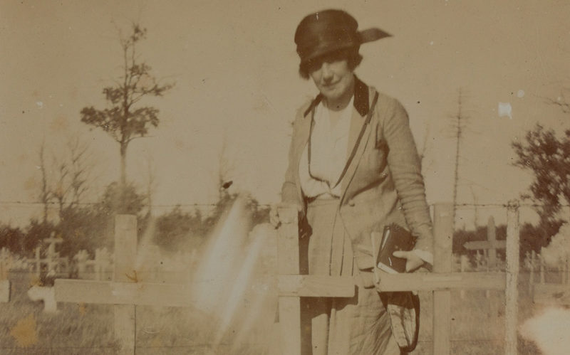 Helen McKie standing by the grave of her brother Douglas McKie, 1919