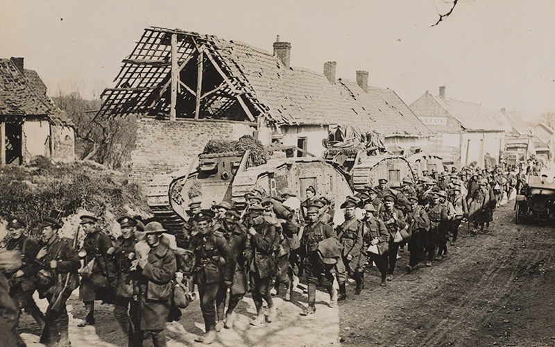 Troops passing tanks on a road in France, Spring 1918