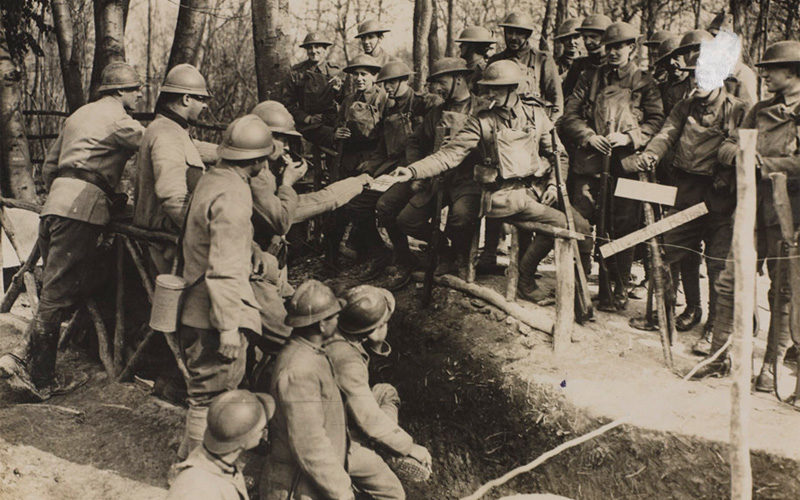 British and French troops outside a dug out, 1918