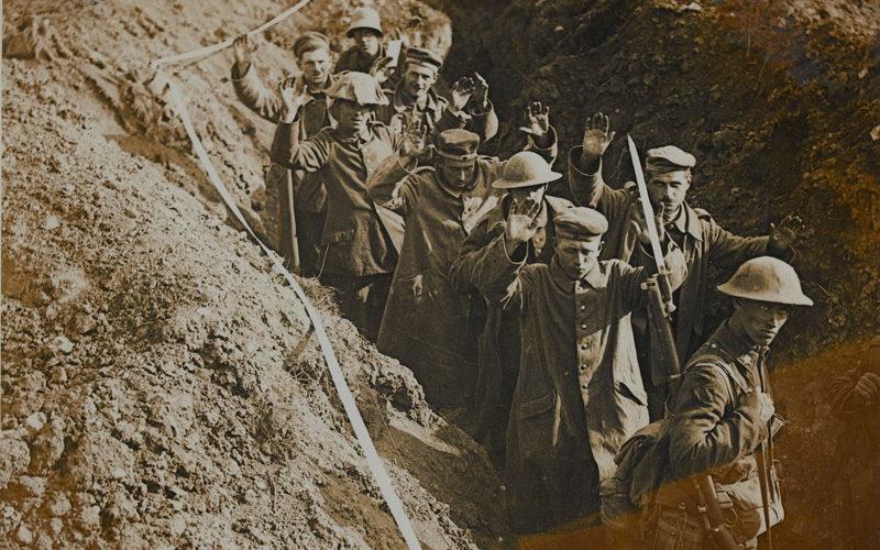 Canadians escort German prisoners through a communication trench, August 1918